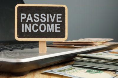 Passive income concept. Notebook and stack of cash.